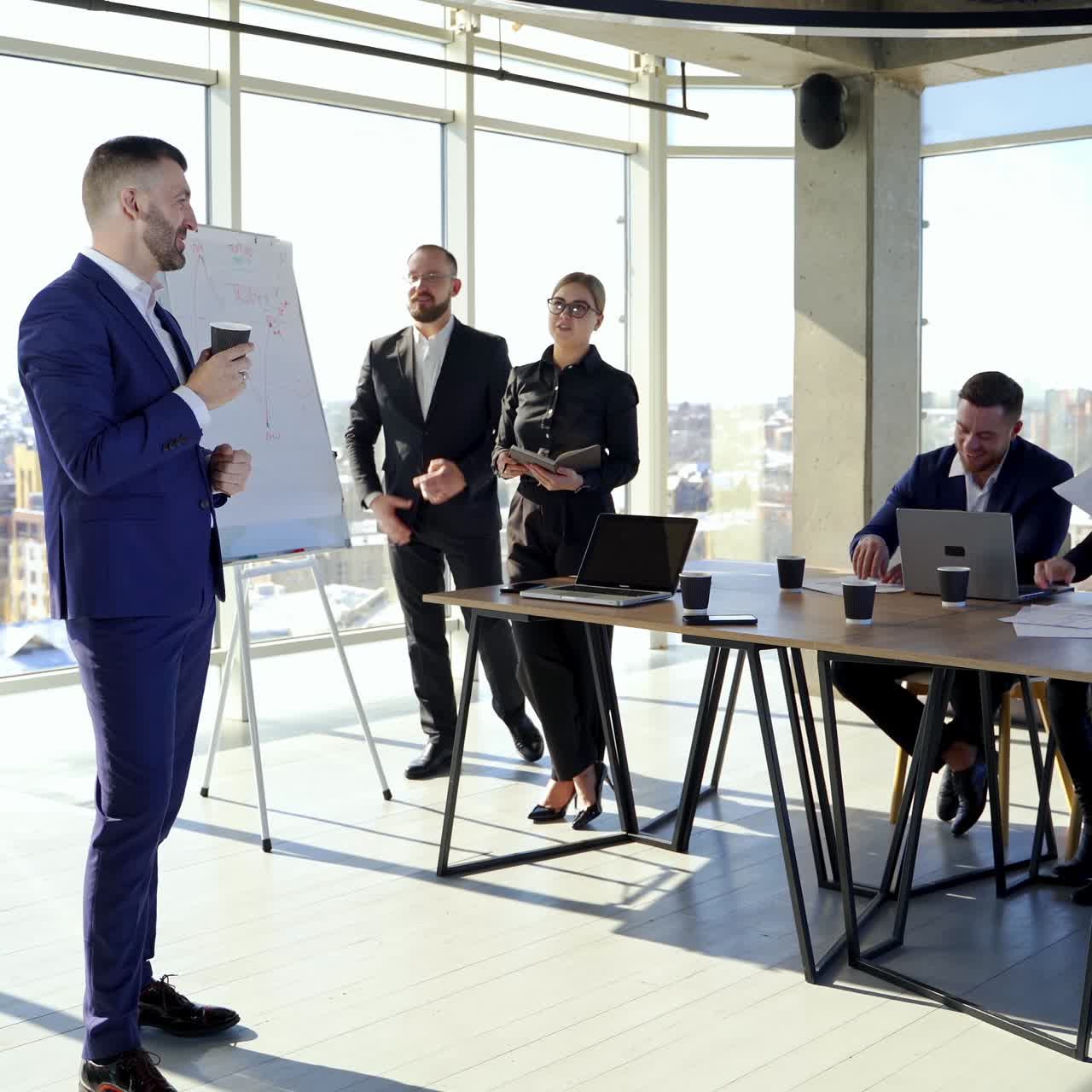 Group business meeting in stylish office. Handsome businessman thinking about new project