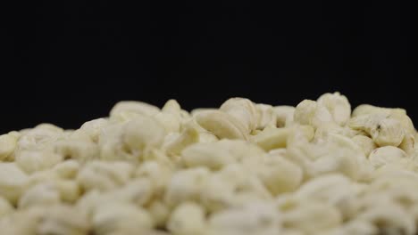 close-up of cashew nuts on a black background