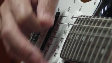 closeup of a man practicing playing the guitar spot focus has a beautiful scene