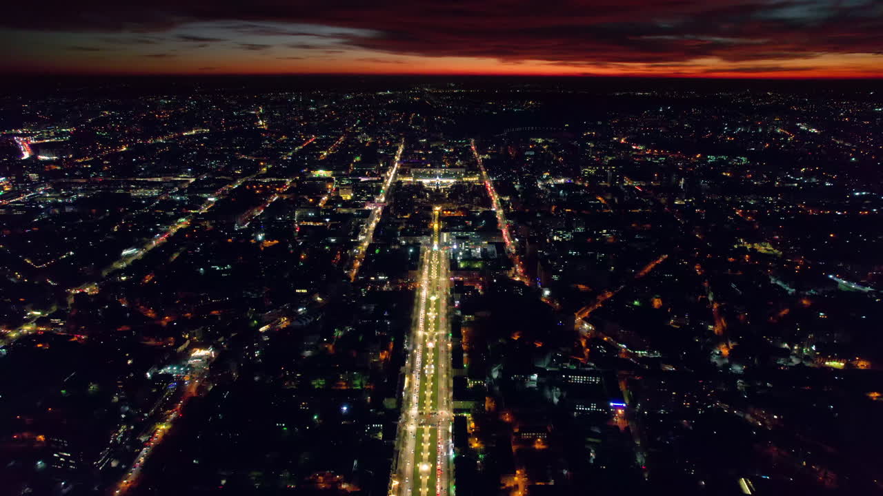 Aerial drone view of Chisinau at sunset, Moldova. View of city centre with multiple buildings, roads with traffic, illumination