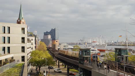 Train-driving-on-tracks-in-Hamburg-City-with-Elbphilharmonie-in-background