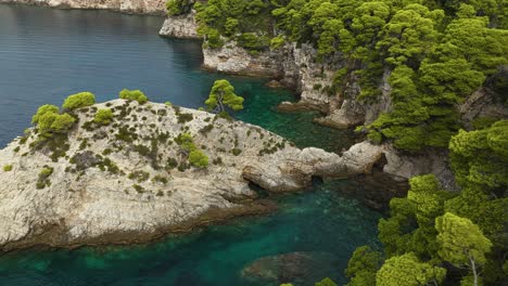 vegetated rock cliffs of kalamota island near dubrovnik in adriatic sea, croatia