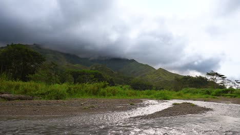 Mountain-range-timelapse-with-river-stream-as-the-foreground