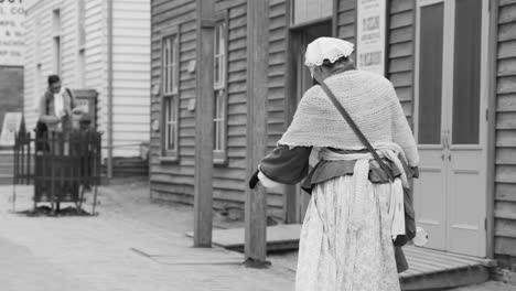 woman walking towards a man on a street