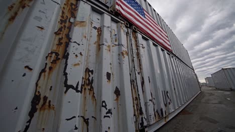 rusty shipping containers with american flag