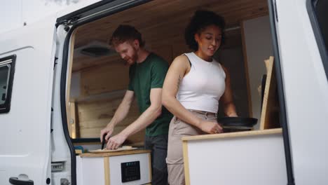 Couple cooking in their campervan