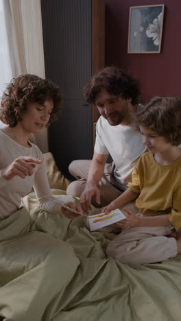 family reading a card together in bed