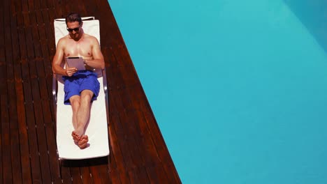 Handsome-man-using-tablet-on-deck-chair