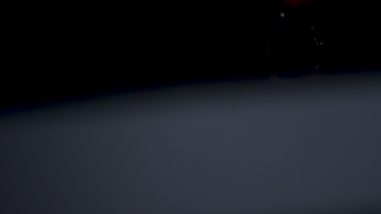 Blue lens flare blinking over black background