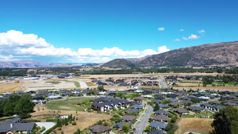 aerial of resort suburban houses in wanaka on a sunny day, south island new zealand