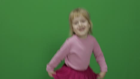 Happy-three-years-old-girl.-Cute-blonde-child.-Dancing-and-make-faces