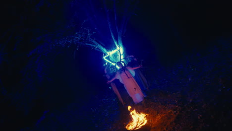 night ritual under a glowing tree