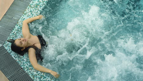 relaxed woman relaxing in whirlpool indoor