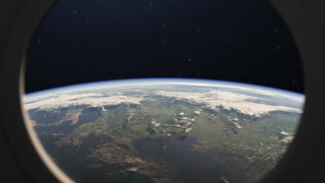 vista del planeta tierra desde la ventana de la puerta de la estación espacial