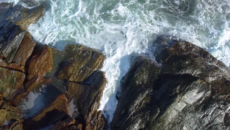 aerial landscape view (drone shot) of sea waves crashing against the rocks at khao laem ya, rayong, thailand