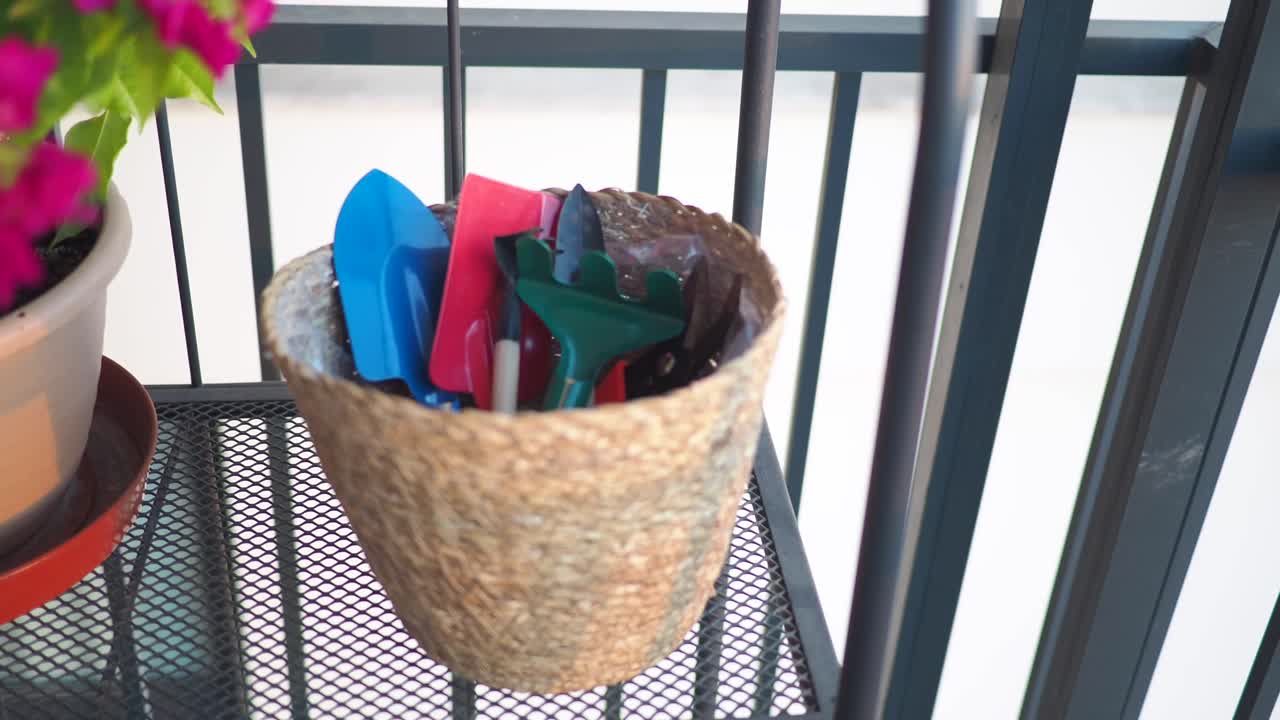 Gardening tools and flowers on a balcony