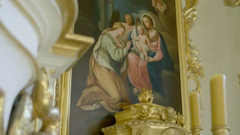gold-embellished painting depicting a biblical scene, part of the altar in a historic chapel