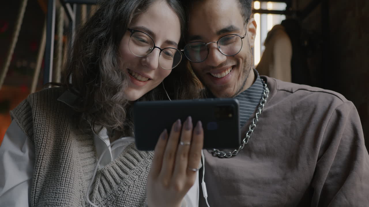 Couple enjoying a video call in a cafe