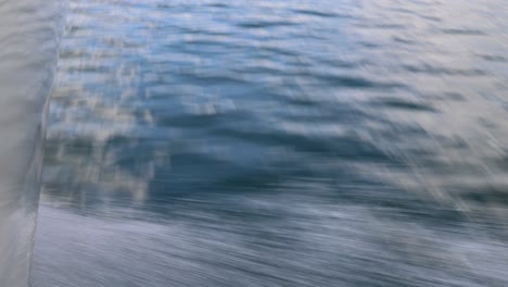 close up of the lake water as a motorboat races over the lake