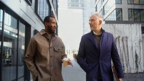 two businessmen talking outdoors