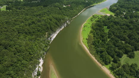 a winding river surrounded by lush green forests in beaver lake, arkansas, aerial view