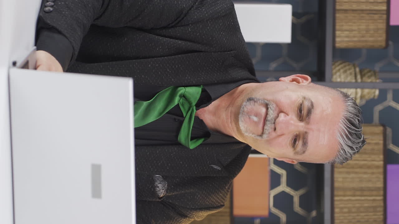 우울하고 긴장된 사업가가  ⁇ 타이를 풀고 있는 수직 영상입니다.