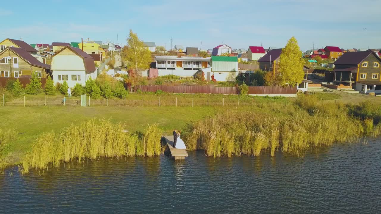 신혼 부부 가 큰 강 위쪽 시야 근처 의 기지 에서 포옹 하고 있다