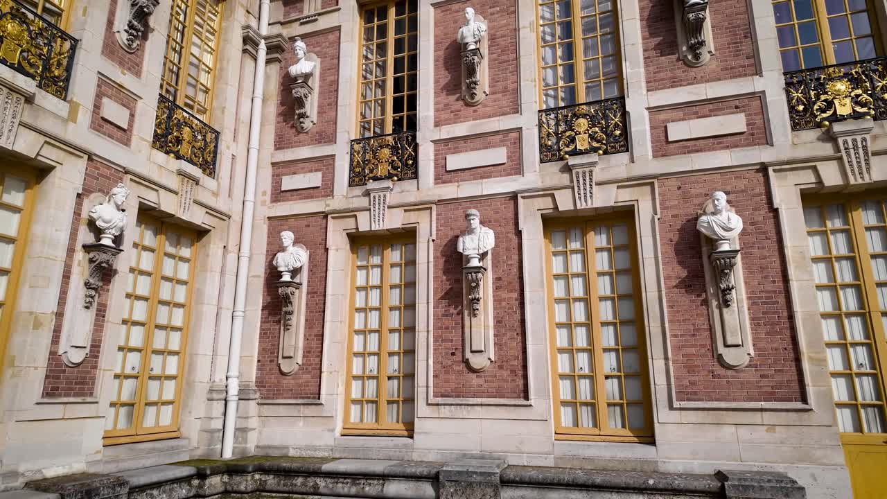 Cinematic 4K low-angle panoramic footage of the Palace of Versailles facade, showcasing textures, materials, sculptures, and architectural details of this iconic French landmark
