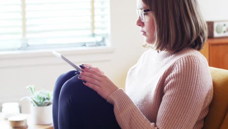 Beautiful-woman-using-digital-tablet-in-living-room