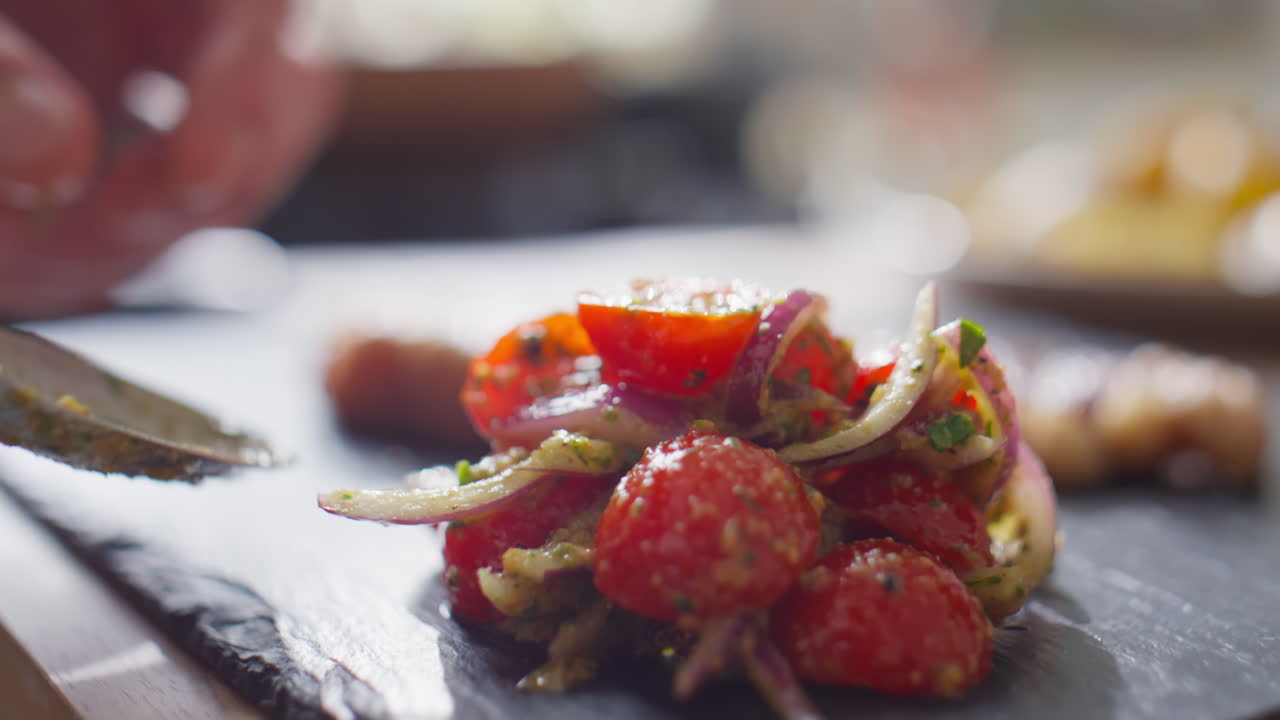Putting Tomato Salad on Board as Side Dish
