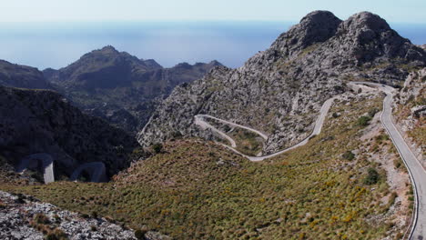 coll dels reis winding road through the mountain on a sunny day in majorca, spain