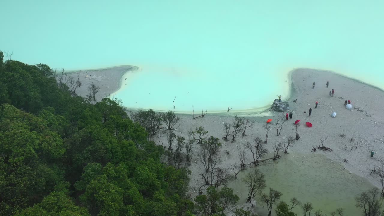 beach shoreline of extreme neon sulfur lake at Kawah Putih in Bandung Indonesia