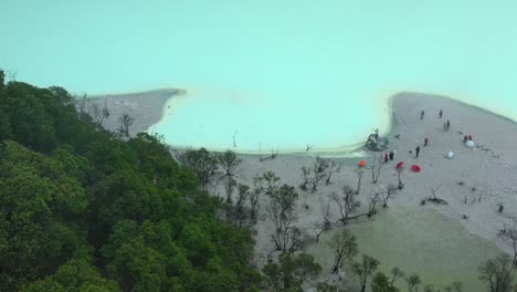beach shoreline of extreme neon sulfur lake at kawah putih in bandung indonesia