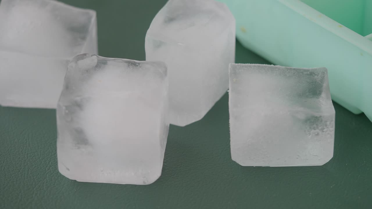 Ice Cubes on a Green Surface