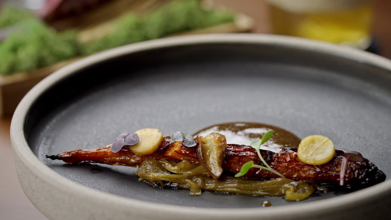 A beautifully plated dish with carrots and gourmet presentation