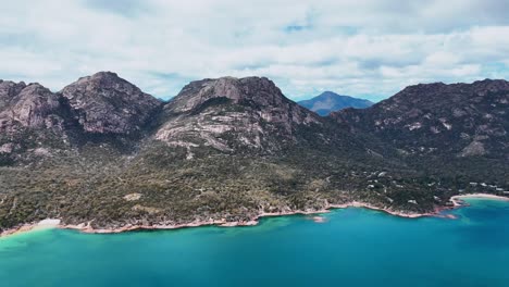 stunning aerial footage of tasmanian mountain with turquoise blue water 4k australia