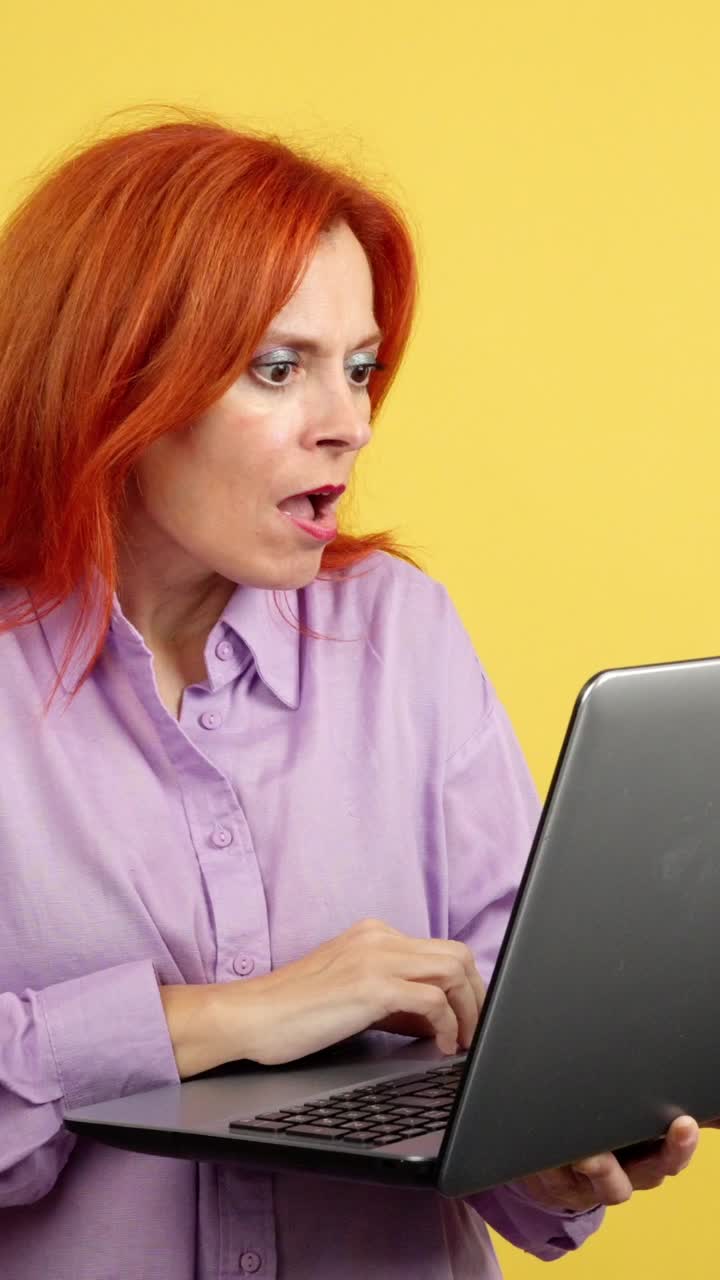Woman looking shocked at laptop
