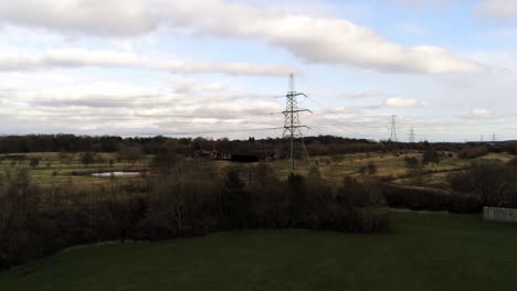 electricity distribution power pylon overlooking british parkland countryside