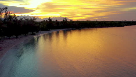 tropical beach sunset with golden reflections