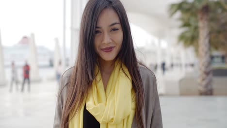 Joyful-grinning-woman-outside-in-yellow-scarf