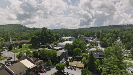 Highlands-North-Carolina-Aerial-v15-cinematic-low-flyover-town-across-main-street-towards-Harris-lake-capturing-charming-community-and-Sunset-rock-mountainscape---Shot-with-Mavic-3-Cine---July-2022