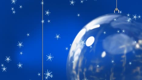 Animation-of-snow-falling-over-christmas-bauble-decorations-on-blue-background