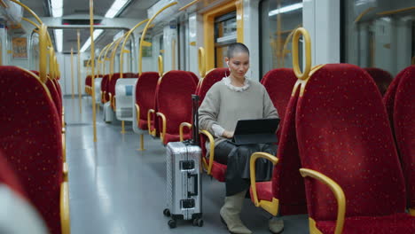 woman working on tablet on a train