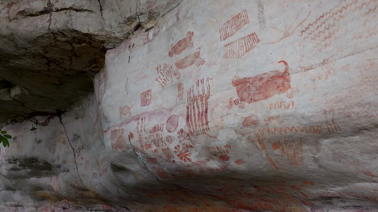 Drone crane shot of a cliff showing ancient paintings