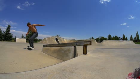 man does a grind on their skateboard down a rail