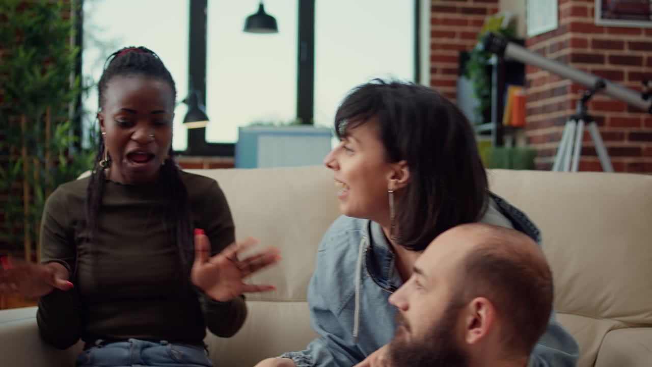 Group of friends enjoying funny conversation at house party