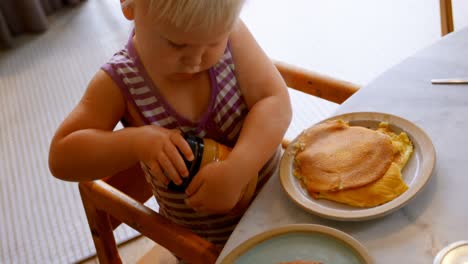 girl opening lid of jar at home 4k