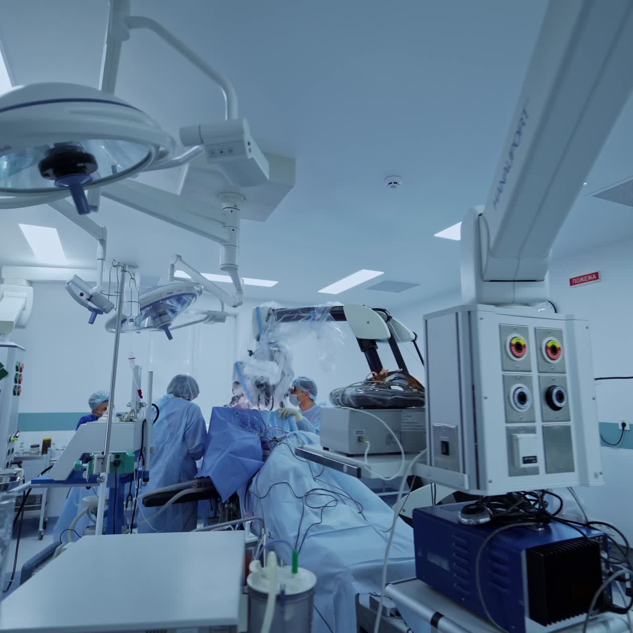 View from the side on experienced surgeons with medical tools during operation. Health treatment concept