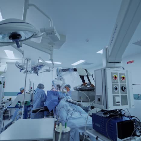 view from the side on experienced surgeons with medical tools during operation. health treatment concept