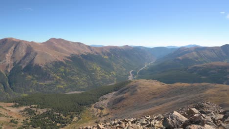 highway i-70 running through a colorado mountain pass on a cloudless day, tilt